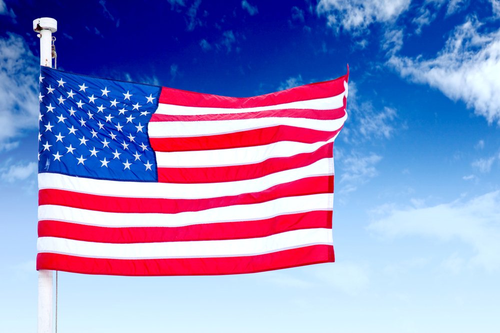 American flag with a sky as a background