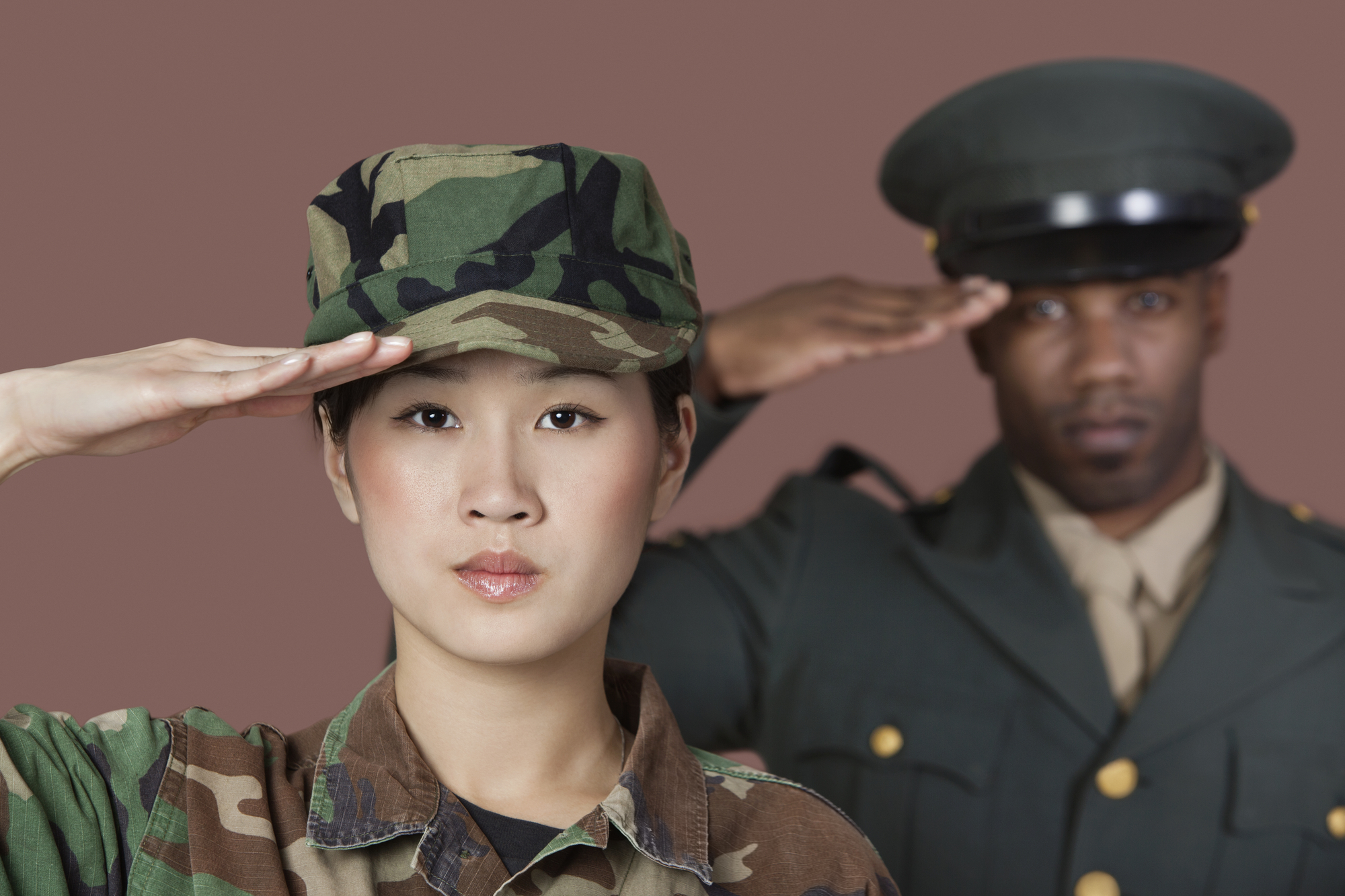 Female Marine Corps soldier and male officer saluting