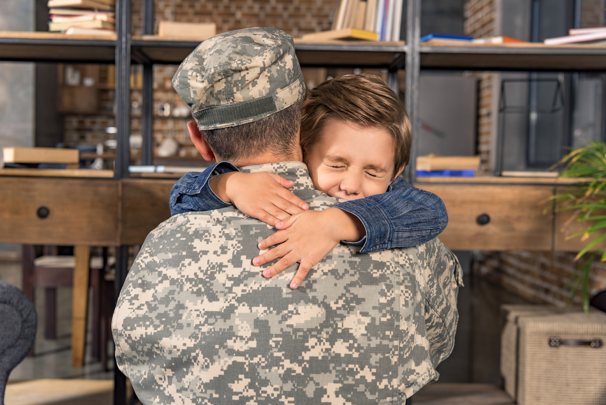 Military father and son embracing